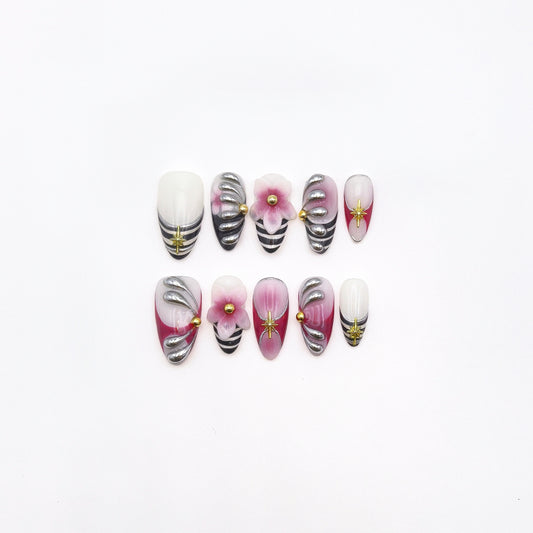 Set of decorative false nails with floral and zebra pattern on a white background